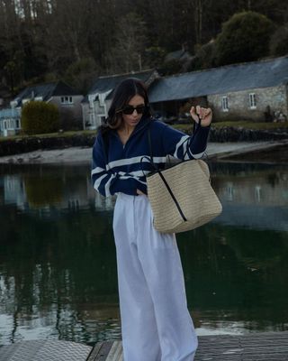 @_jessicaskye wearing a striped jumper and white linen trousers