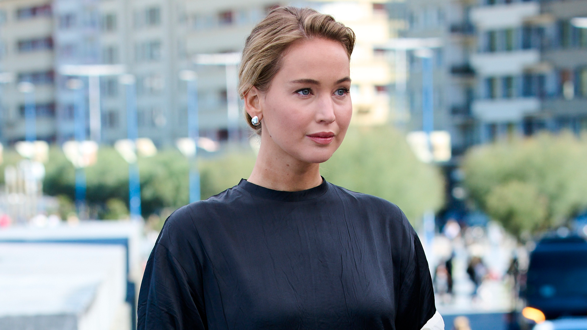 Jennifer Lawrence attended a film festival in spain wearing a T-shirt, pants, and a dress-like train