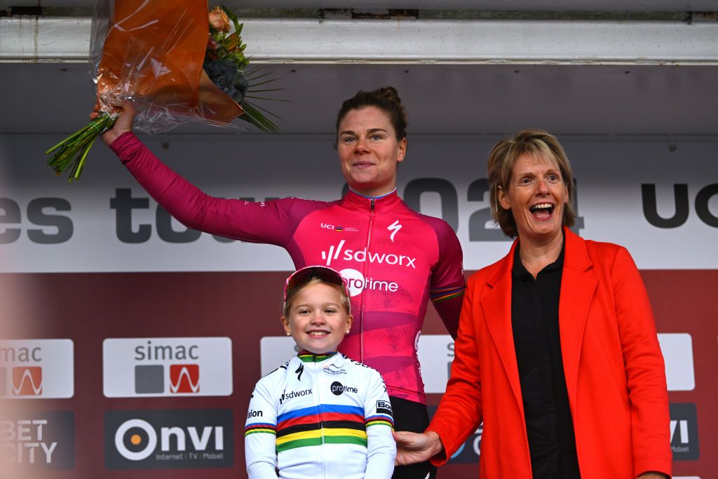 ARNHEM NETHERLANDS OCTOBER 13 Lotte Kopecky of Belgium and Team SD Worx Protime puts on the Purple UCI Womens WorldTour Leader Jersey on the podium ceremony after the 26th Simac Ladies Tour 2024 Stage 6 a 1458km stage from Arnhem to Arnhem UCIWWT on October 13 2024 in Arnhem Netherlands Photo by Luc ClaessenGetty Images