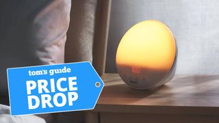 Philips SmartSleep and Wake-Up Light on a bedside table in a dimly lit bedroom