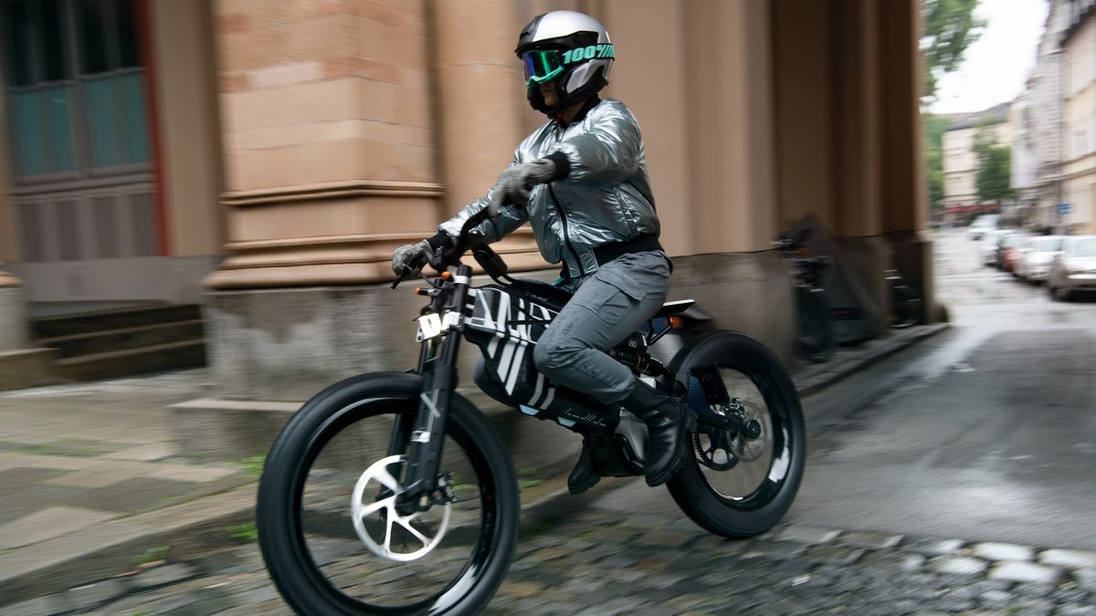 Man riding e-bike through city