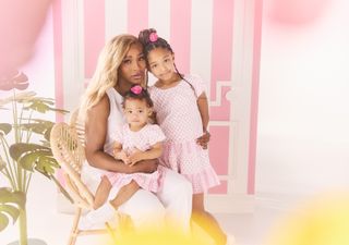 A photo of Serena Williams and her two daughters wearing pink dotted dresses.