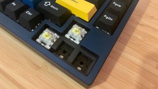 Close up on Lemokey P1 Pro arrow keys with keycaps removed and two switches removed