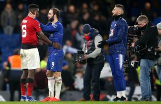 Manchester United's Paul Pogba and Chelsea's Gonzalo Higuain embrace