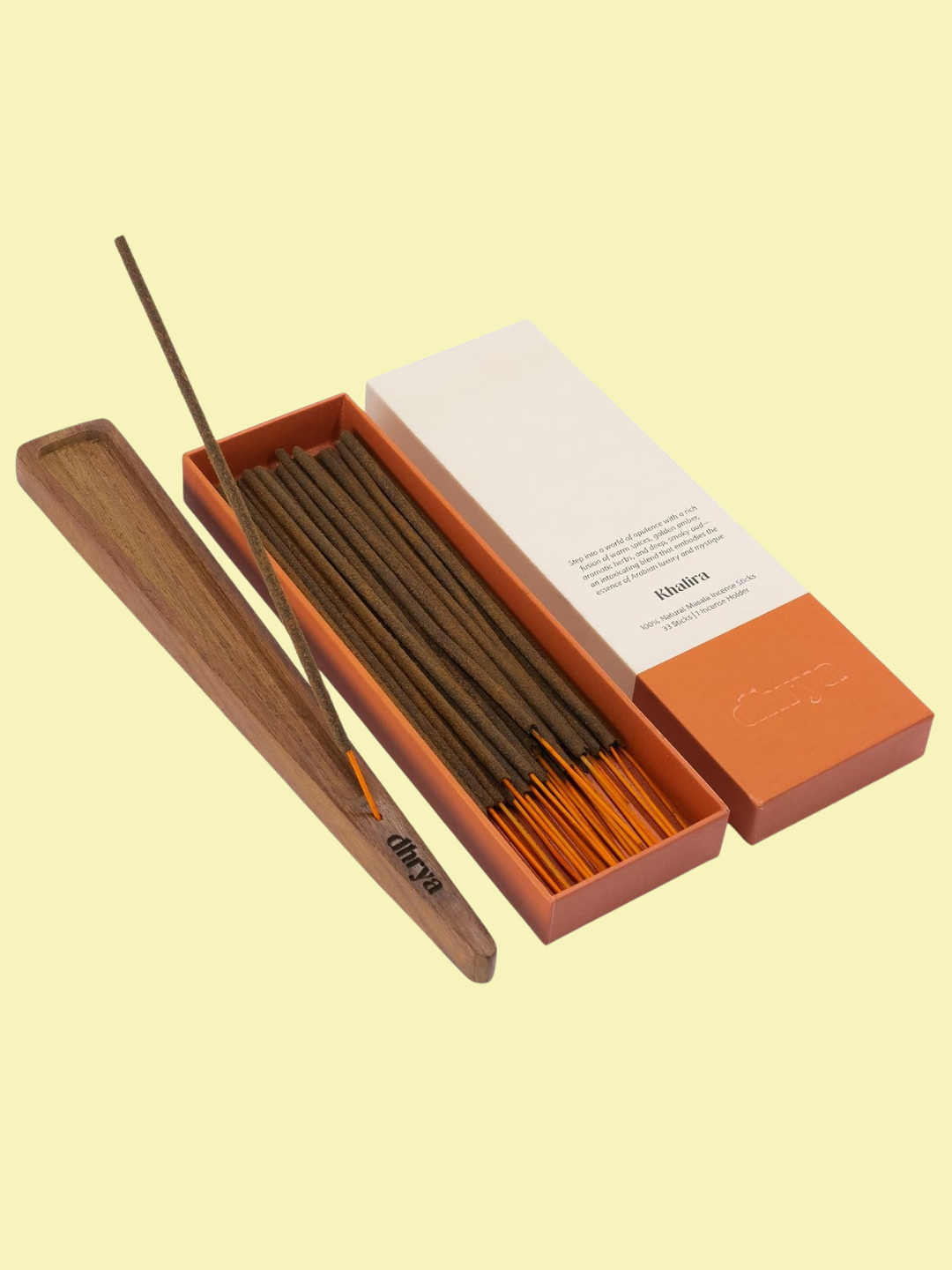 A box of orange incense sticks from dhyra with a wood holder