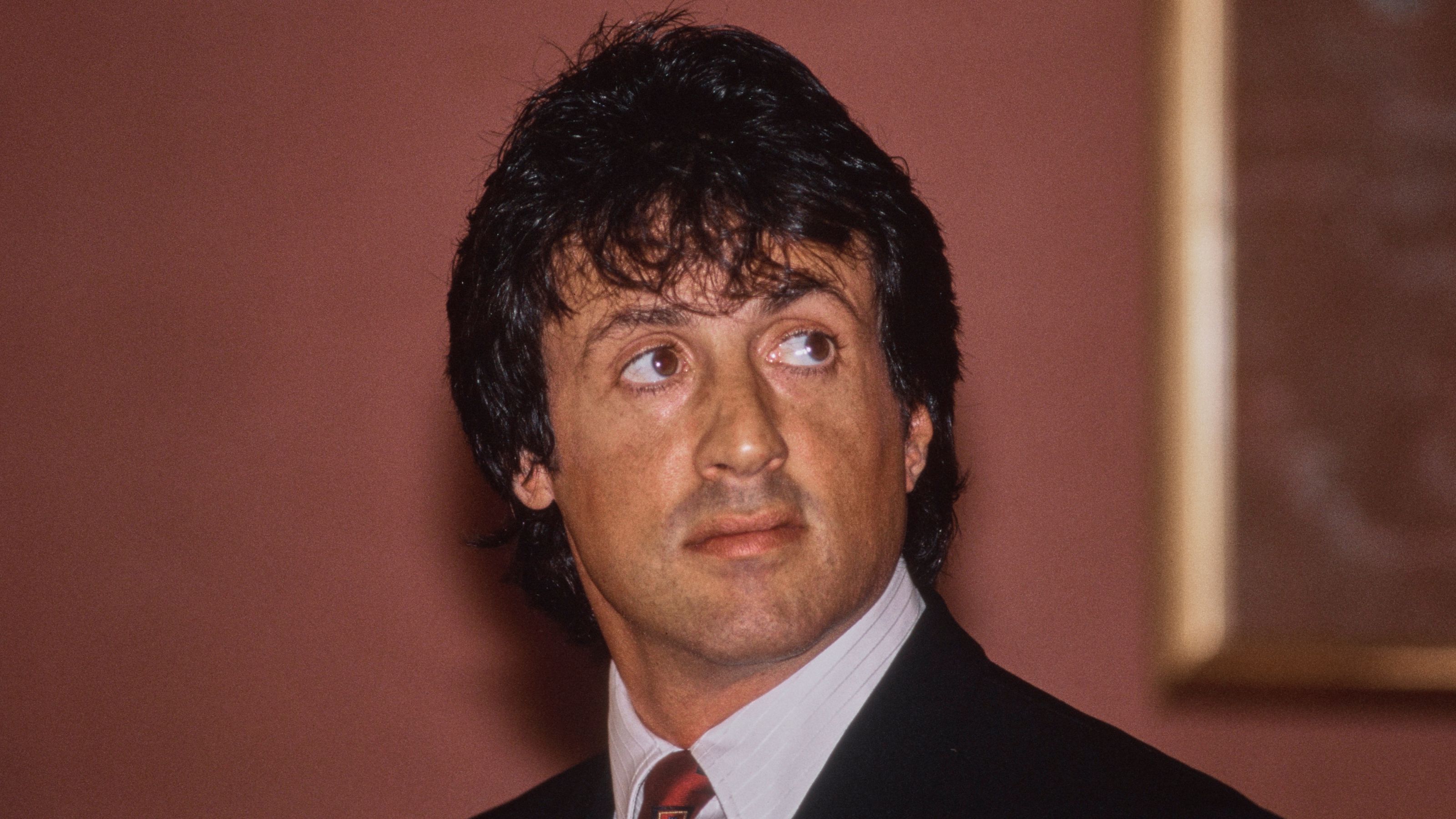 sylvester stallone on a red background