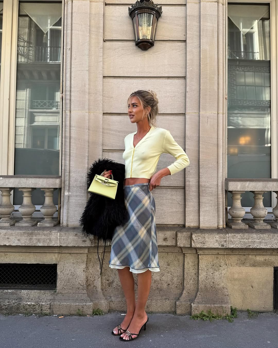 @emilisindlev wearing a butter yellow cardigan with a gingham skirt