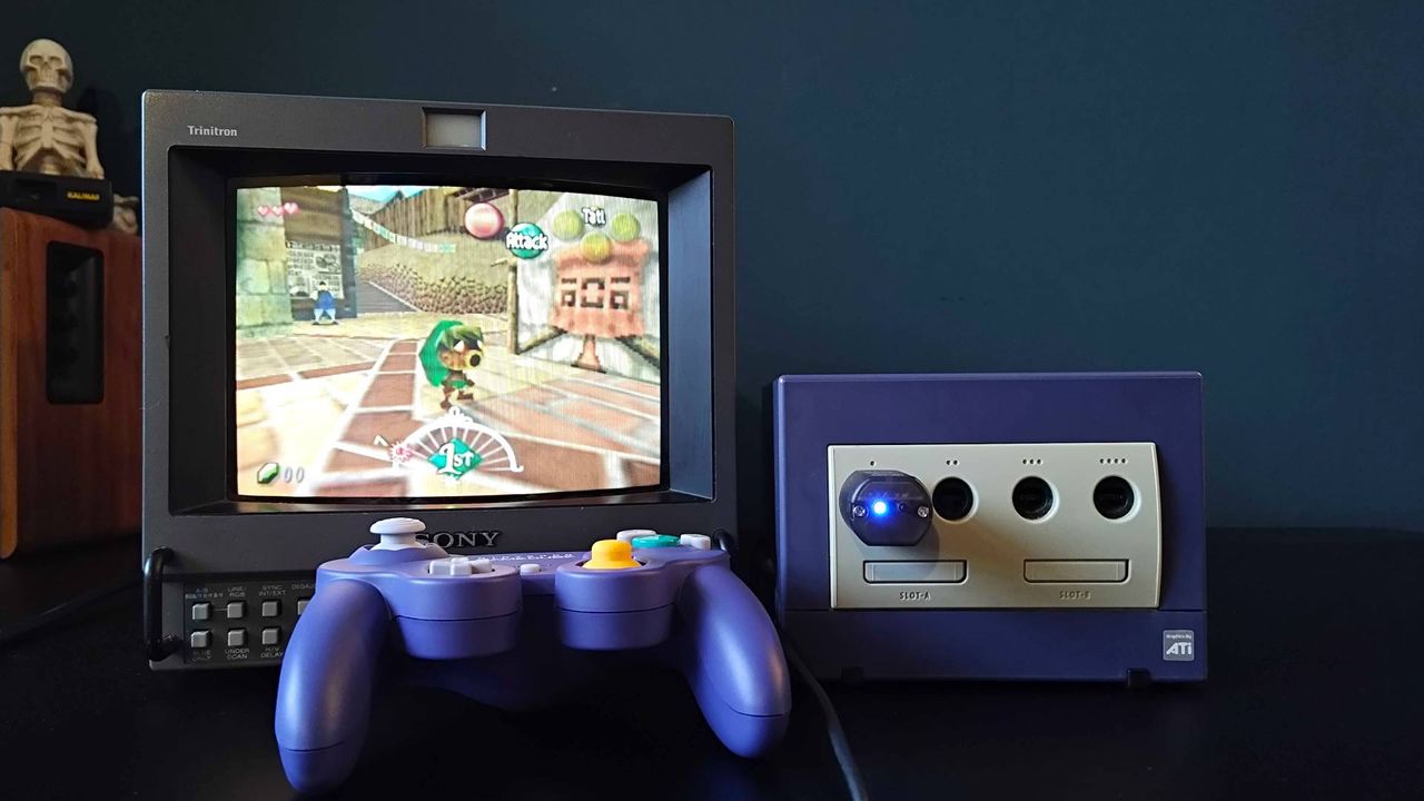 Switch 2 GameCube controller sitting in front of original console with Blueretro Wireless Adapter in port and Sony PVM CRT with Zelda: Majora's Mask gameplay on screen.