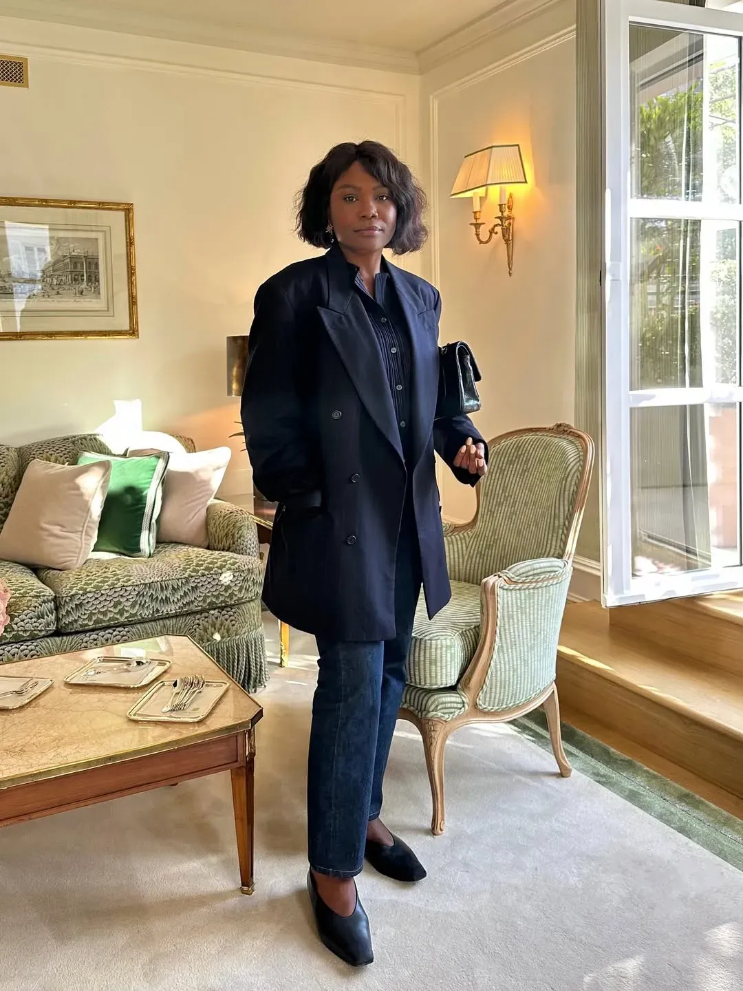 A woman wears jeans with ballet flats indoors