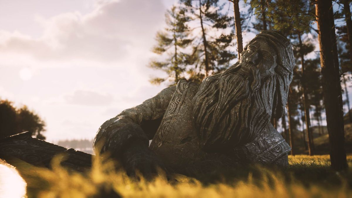 Among The Trolls by Avantgarden Games; a large stone statue of a bearded man laying on a yellow grassy field