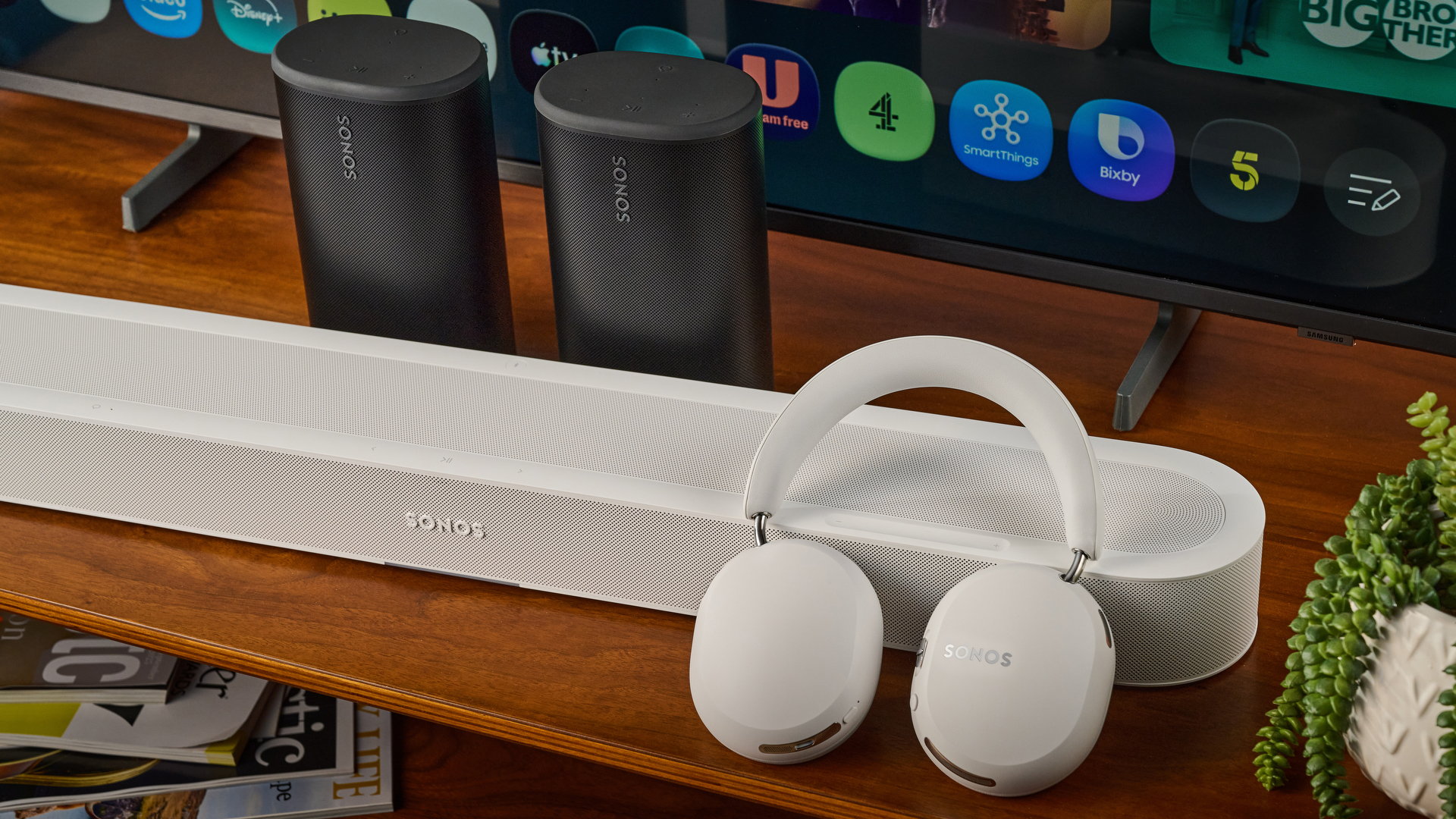 Sonos Ace Ultra balanced against the Sonos Beam Ultra with Sonos Play speakers and TV