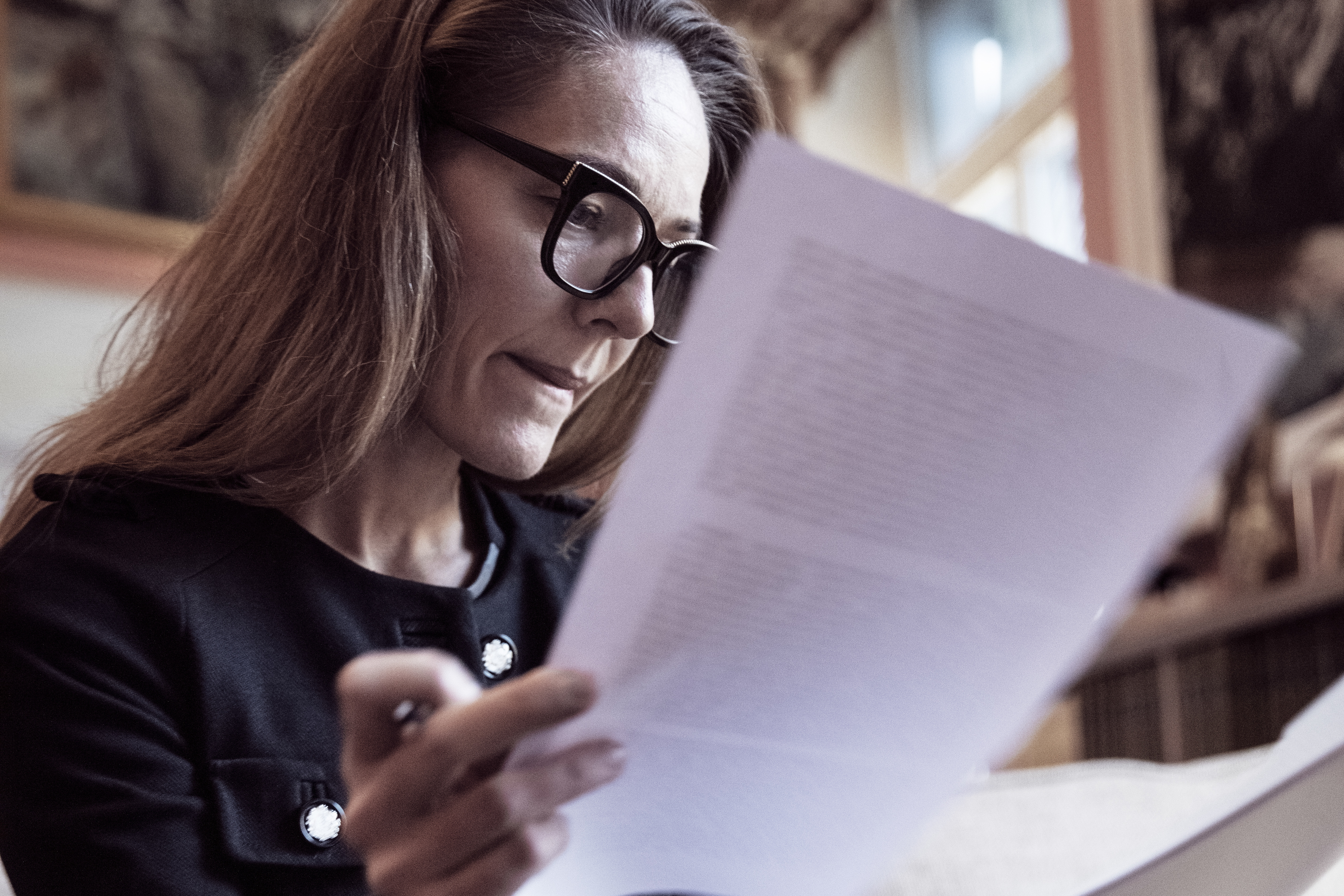 Person looks at insurance policy document.