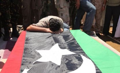 A man mourns during the burial of Libya's rebel military commander Gen. Abdel Fattah Younes