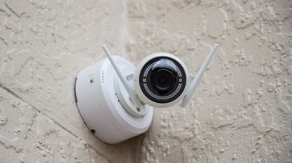 Best security cameras 2022: Image depicts security camera on wall looking directly to camera