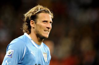 Diego Forlan looks on while playing for Uruguay against the Netherlands in the semi-final of the 2010 World Cup