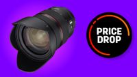 A black Samyang camera superimposed over a purple background. There is a black circle graphic next to the lens with the words "price drop" written on it. 