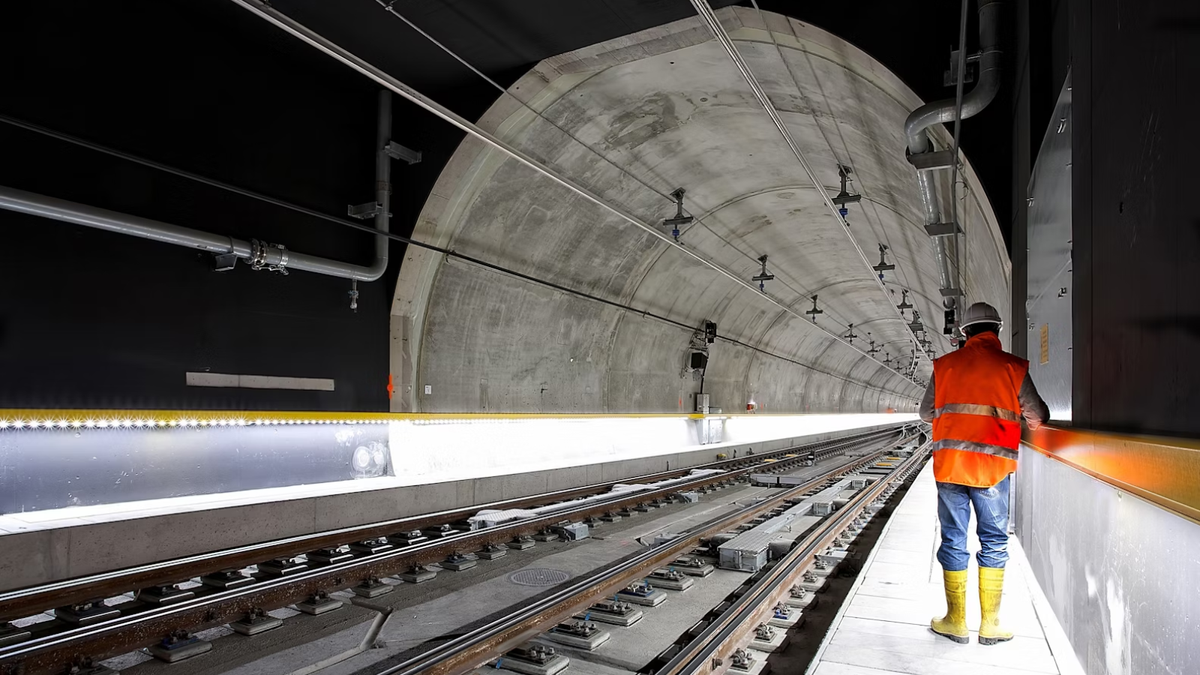 A man using a tablet in a tunnel that&#039;s being engineered