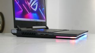 Asus ROG Strix Scar 15 photographed on a table with its lights on, for a review