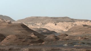 From NASA: "This composite image looking toward the higher regions of Mount Sharp was taken on September 9, 2015, by NASA's Curiosity rover. In the foreground ― about 2 miles (3 kilometers) from the rover ― is a long ridge teeming with hematite, an iron oxide. Just beyond is an undulating plain rich in clay minerals. And just beyond that are a multitude of rounded buttes, all high in sulfate minerals. The changing mineralogy in these layers of Mount Sharp suggests a changing environment in early Mars, though all involve exposure to water billions of years ago."