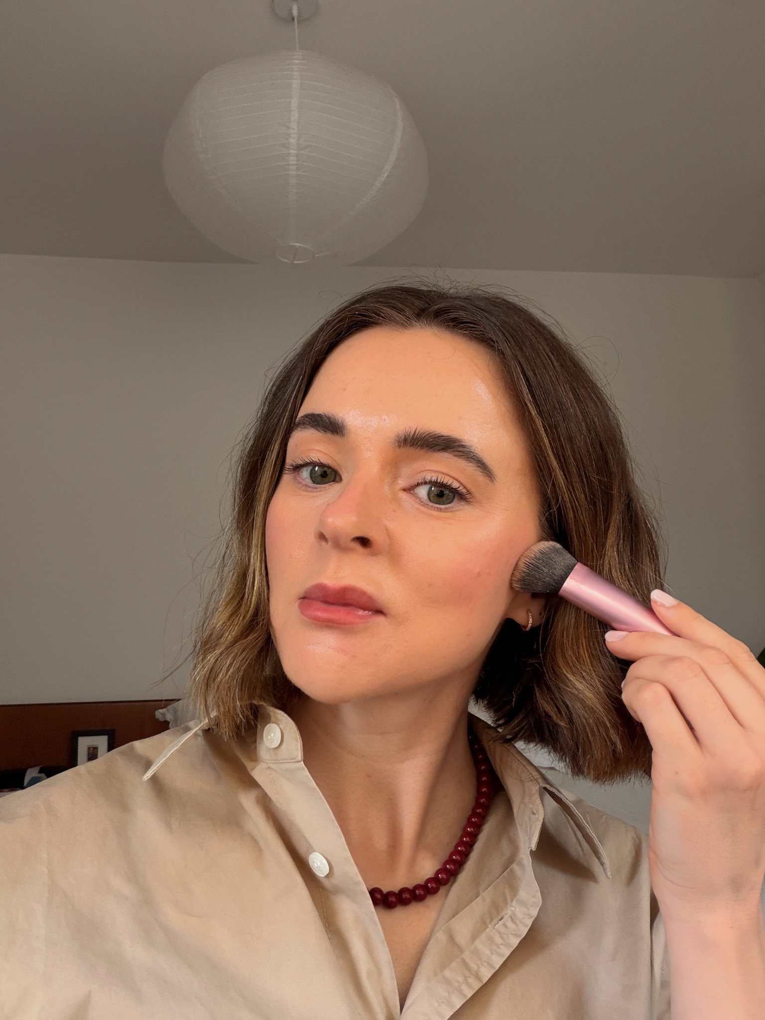 Freelance beauty editor, Grace Day, wearing Rhode Pocket Bronze in Sip