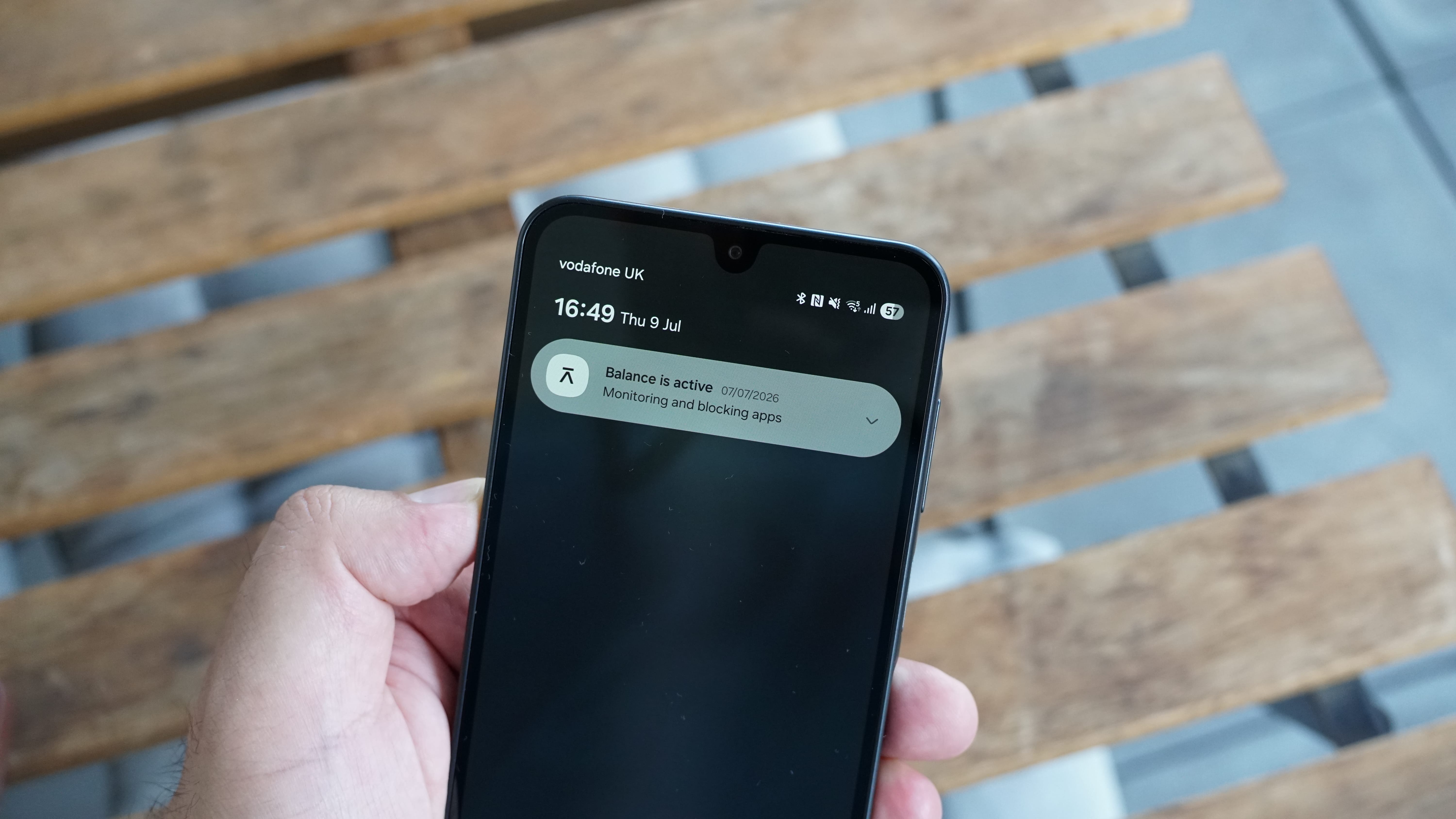 The Balance Phone being held in the hand