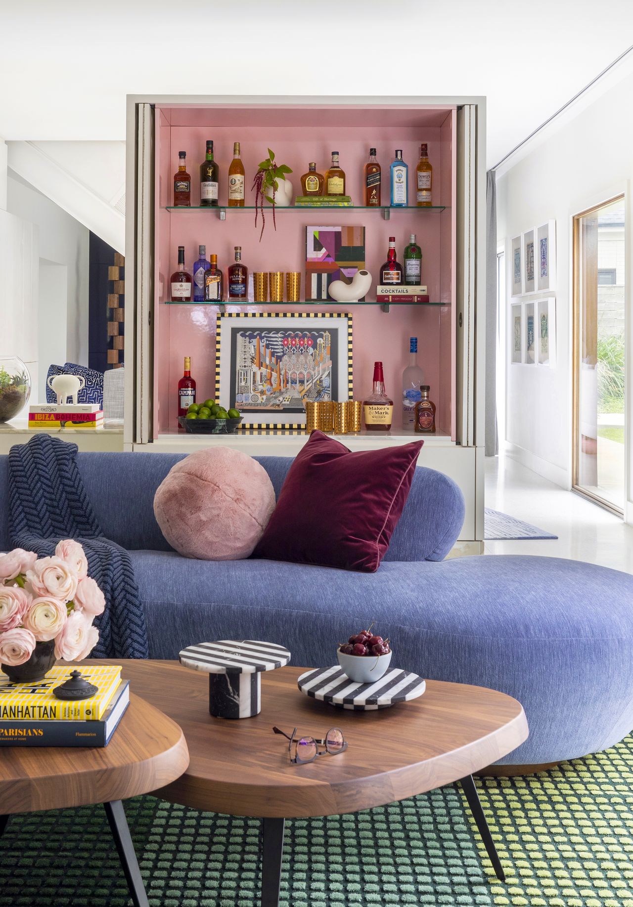 A pink toned bar storage unit inside a living room