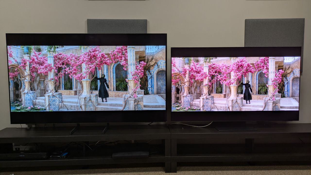 Samsung S85F (left) vs Samsung S95F (right) showing Elphaba from Wicked under a pink tree, both set to Movie mode
