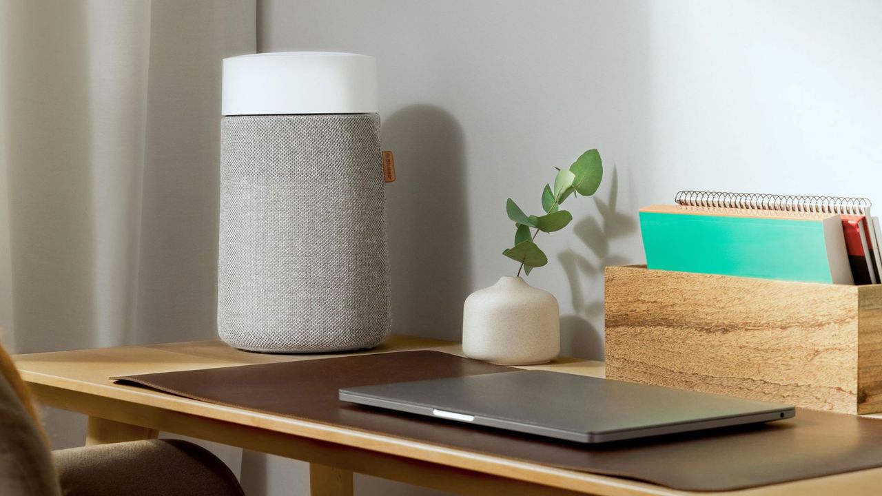 Grey air purifier on a wooden desk