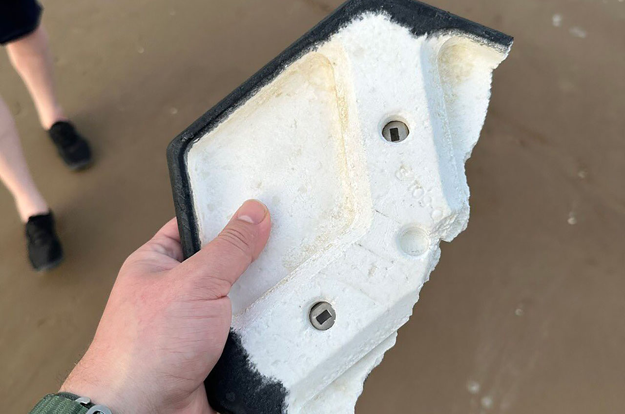Joe Tegtmeyer displays the underside of the ceramic tile that he found on South Padre Island Beach in Texas on Thursday, April 20, 2023, later on the same day that SpaceX launched 18,000 similar tiles on its first Starship and Super Heavy test flight from nearby Boca Chica.
