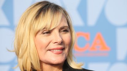 Kim Cattrall looks to the side at a red carpet