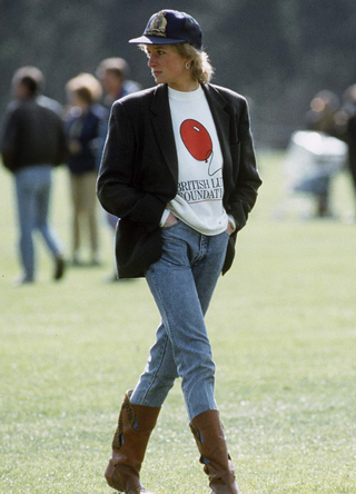 Diana, Princess Of Wales At Guards Polo Club. The Princess Is Casually Dressed In A Sweatshirt With The British Lung Foundation Logo On The Front, Jeans, Boots And A Baseball Cap in 1988