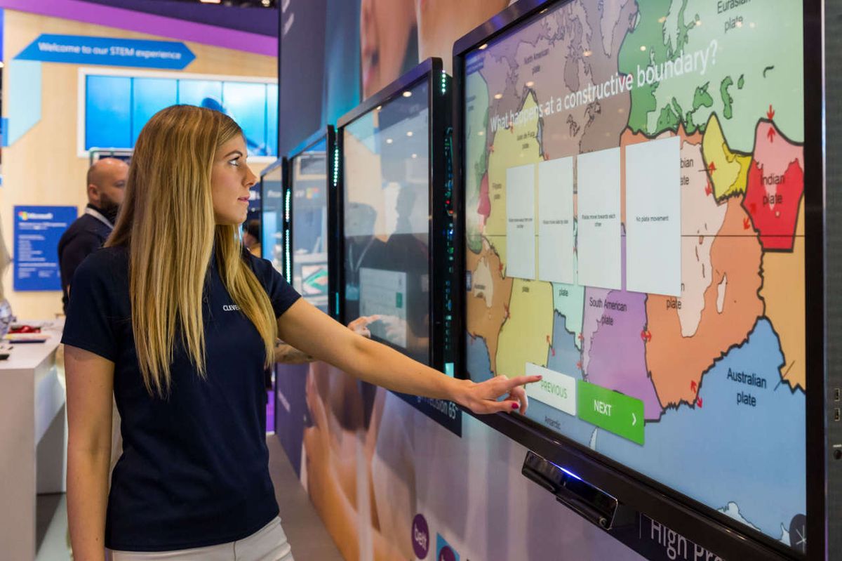 Teen girl touches clevertouch plus display