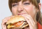 Marie Claire Health news: Woman eating a burger