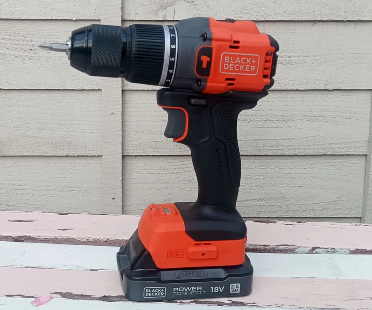 Black and Decker BLD783 18v Cordless Brushless Combi Drill in front of fence