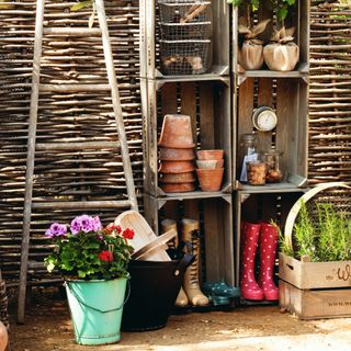 Gardening supplies and wellies in outdoor garden storage