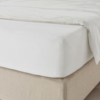 White fitted sheet on a bed
