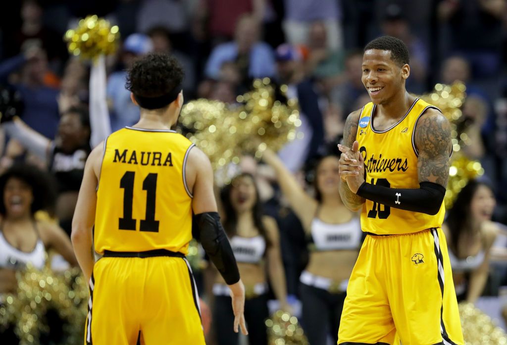 Jairus Lyles #10 congratulates teammate K.J. Maura #11 of the UMBC Retrievers after their 74-54 victory over the Virginia Cavaliers during the first round of the 2018 NCAA Men&amp;#039;s Basketball To