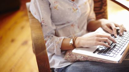 Woman typing on laptop