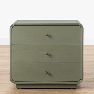 A small olive green nightstand with three drawers