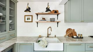 Styled wooden shelf in white kitchen with hydrangeas on the side
