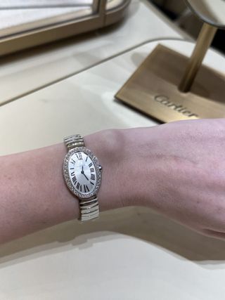 Kristen Nichols trying on a Cartier Baignoire watch.