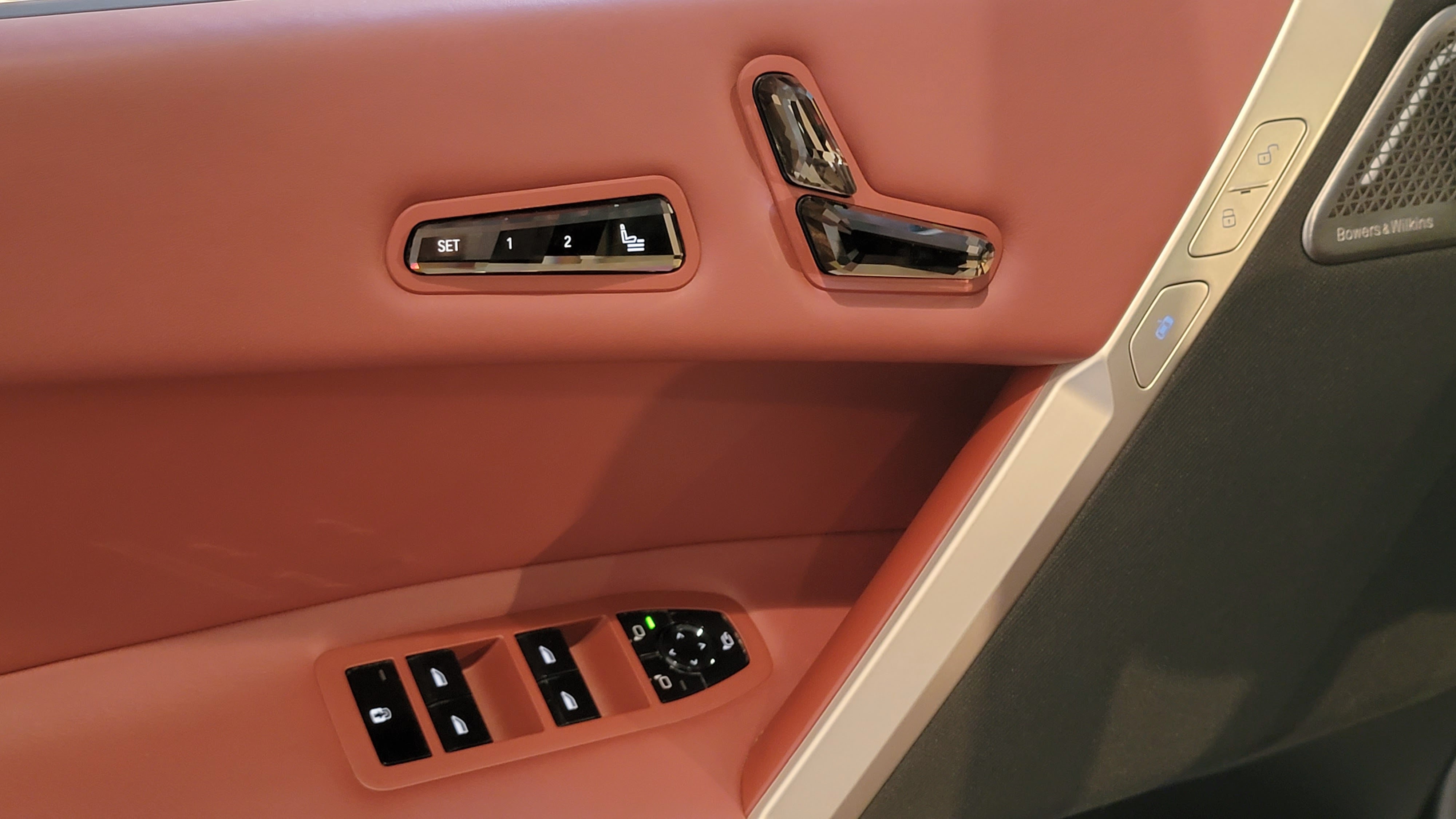 Seat and window controls on door panel of a car