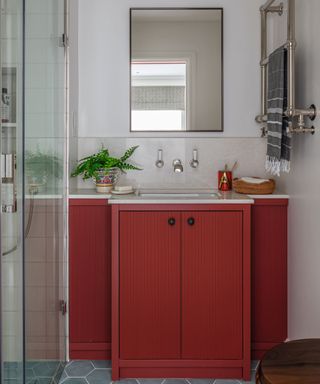 Red vanity unit in awkward shaped bathroom