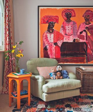 Living room with green armchair, painting, orange side table and rug