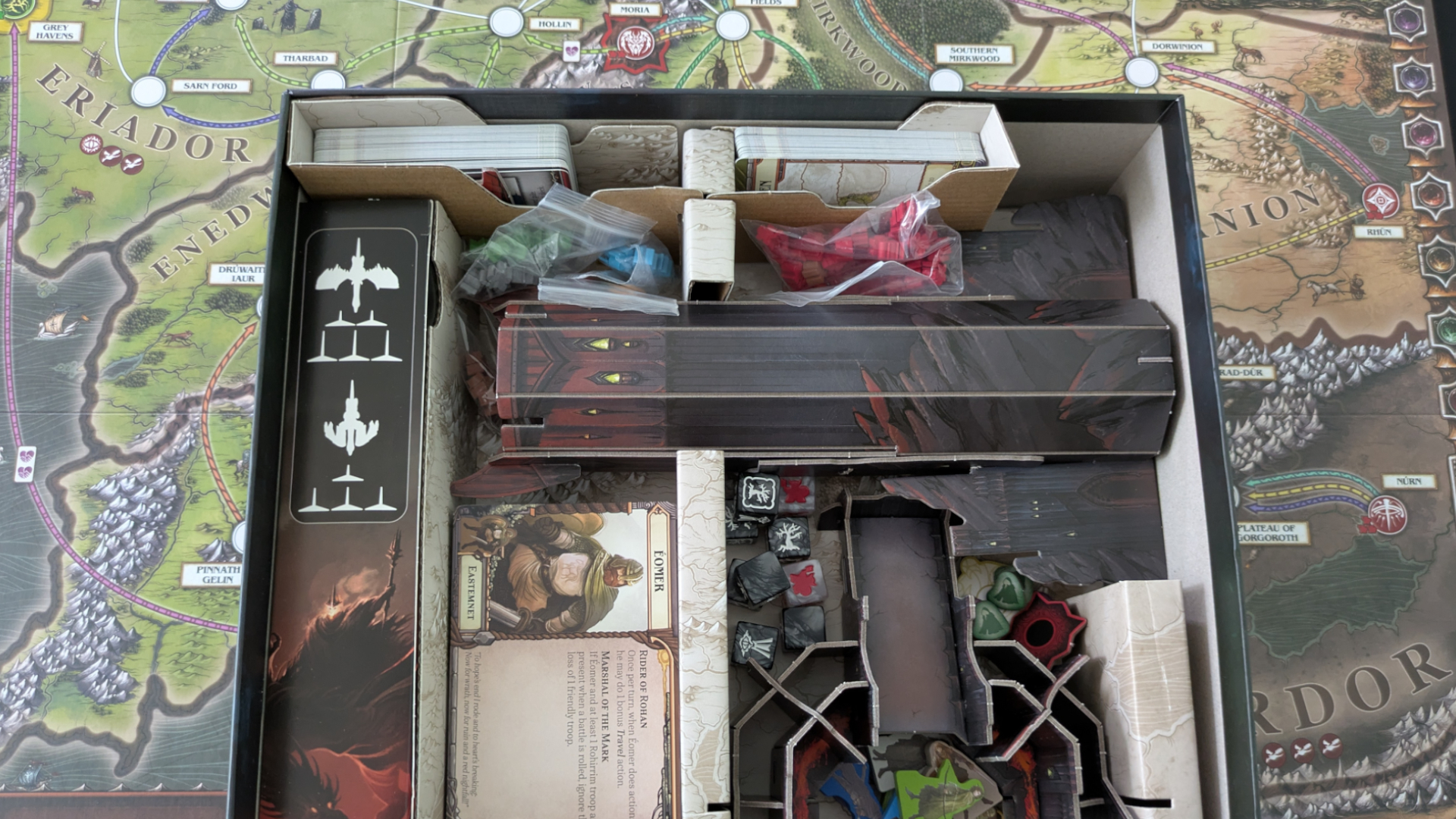 The Fate of the Fellowship box with its many components, seen from abovfe as it sits on the game board
