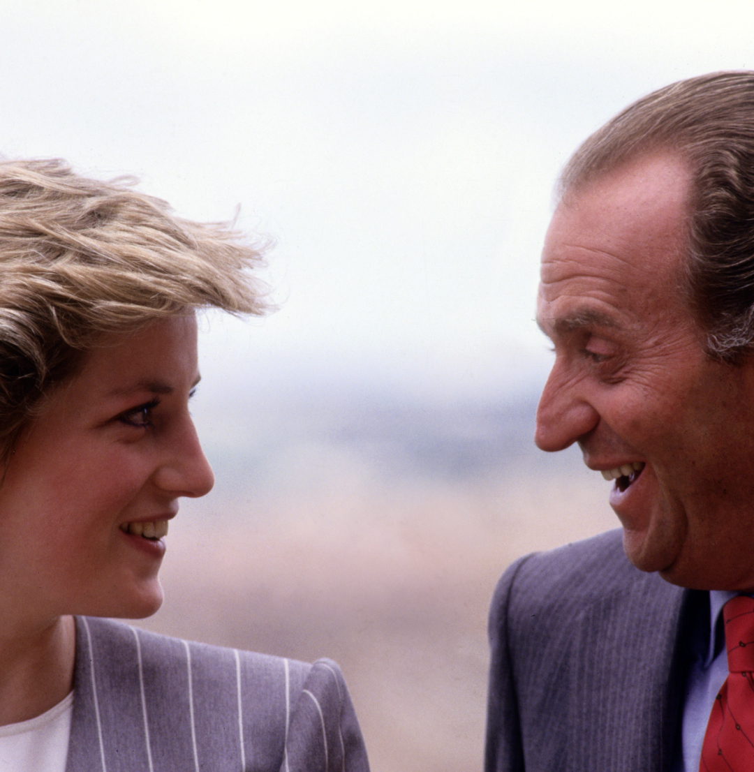 Princess Diana and King Juan Carlos facing each other smiling