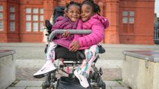 Conjoined sisters Marieme and Ndeye Ndiaye pose for the camera