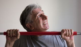 older man doing chin-ups