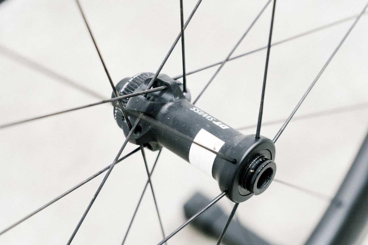 An aero road wheel stands against a white wall