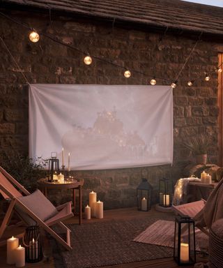 outdoor cinema set up with candles and fairy lights